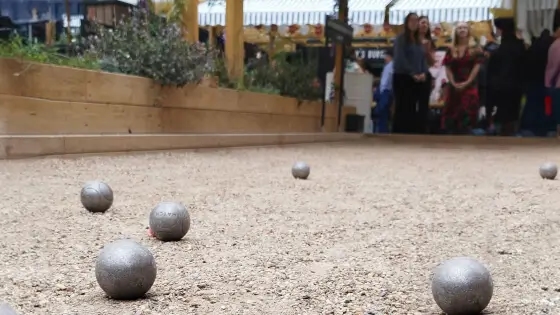 Petanque balls in the foreground, AMP27 team in the background. Half width image should sit alongside the final two paragraphs in the copy block above