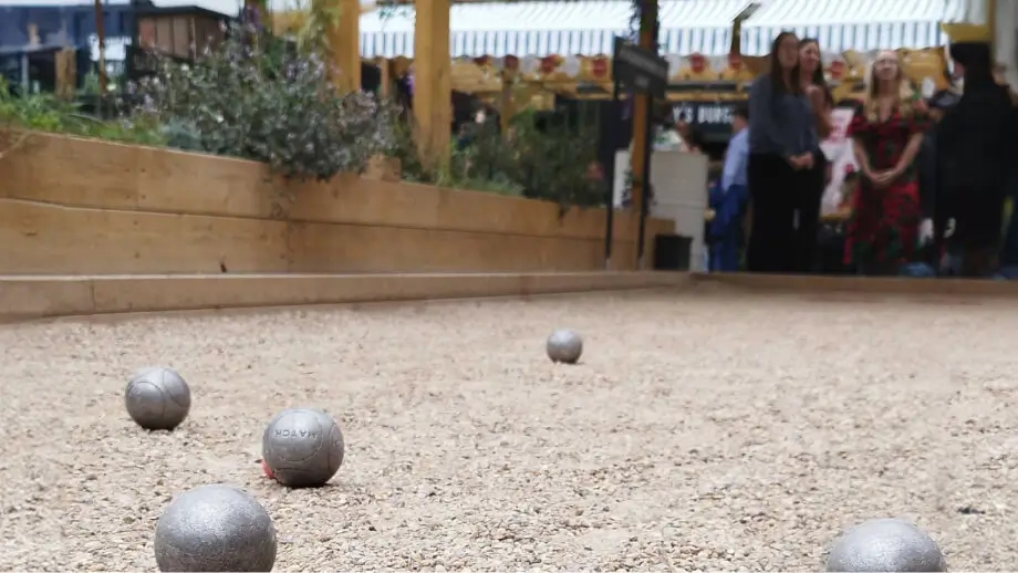 Petanque balls in the foreground, AMP27 team in the background. Half width image should sit alongside the final two paragraphs in the copy block above