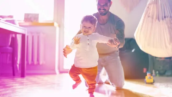 A parent teaches their child to walk