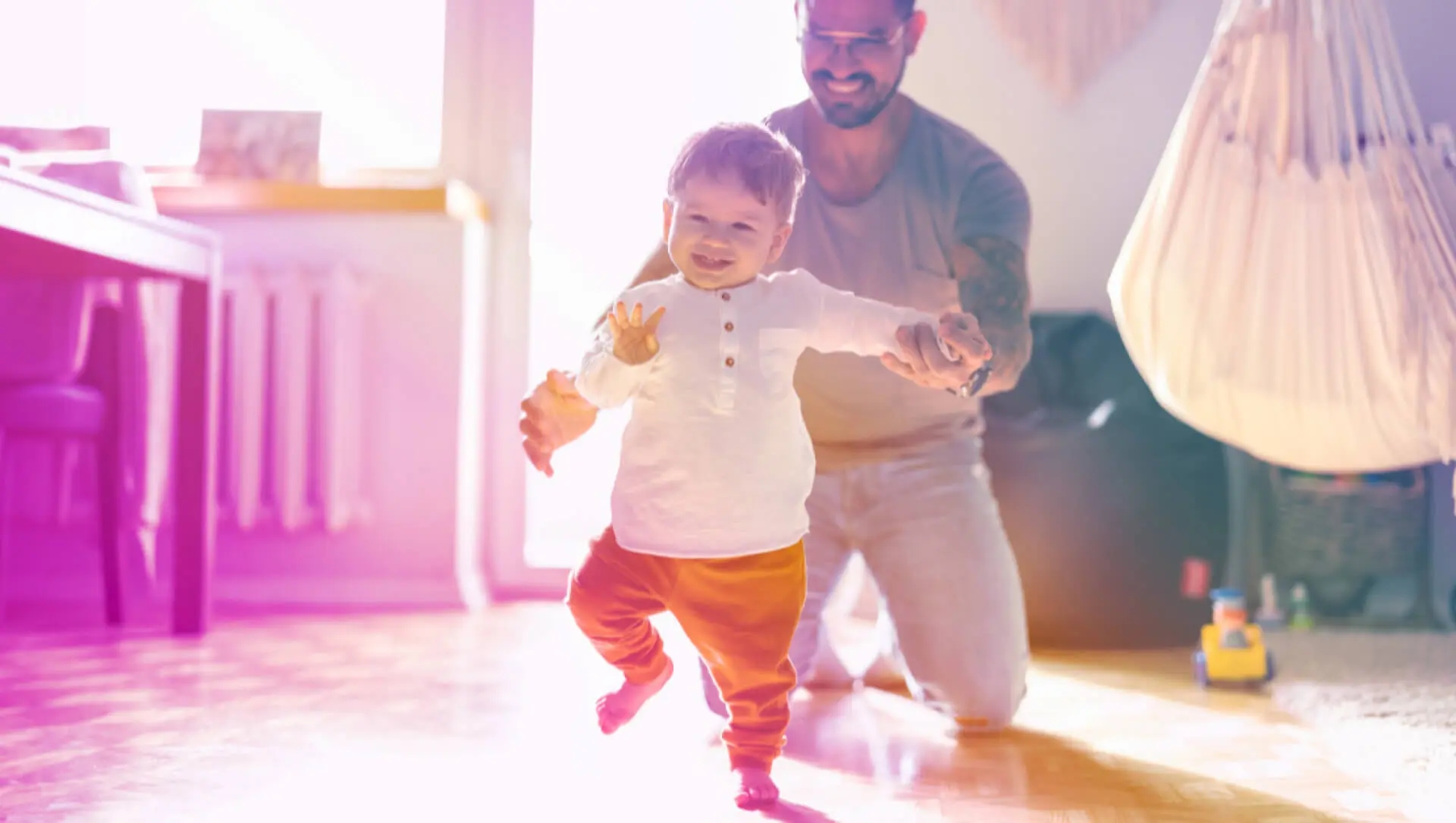 A parent teaches their child to walk