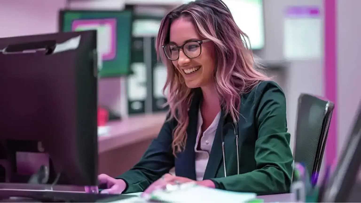 An HCP smiles whilst using a computer